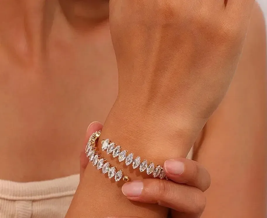 Gold-tone crystal-link bracelet worn on the wrist