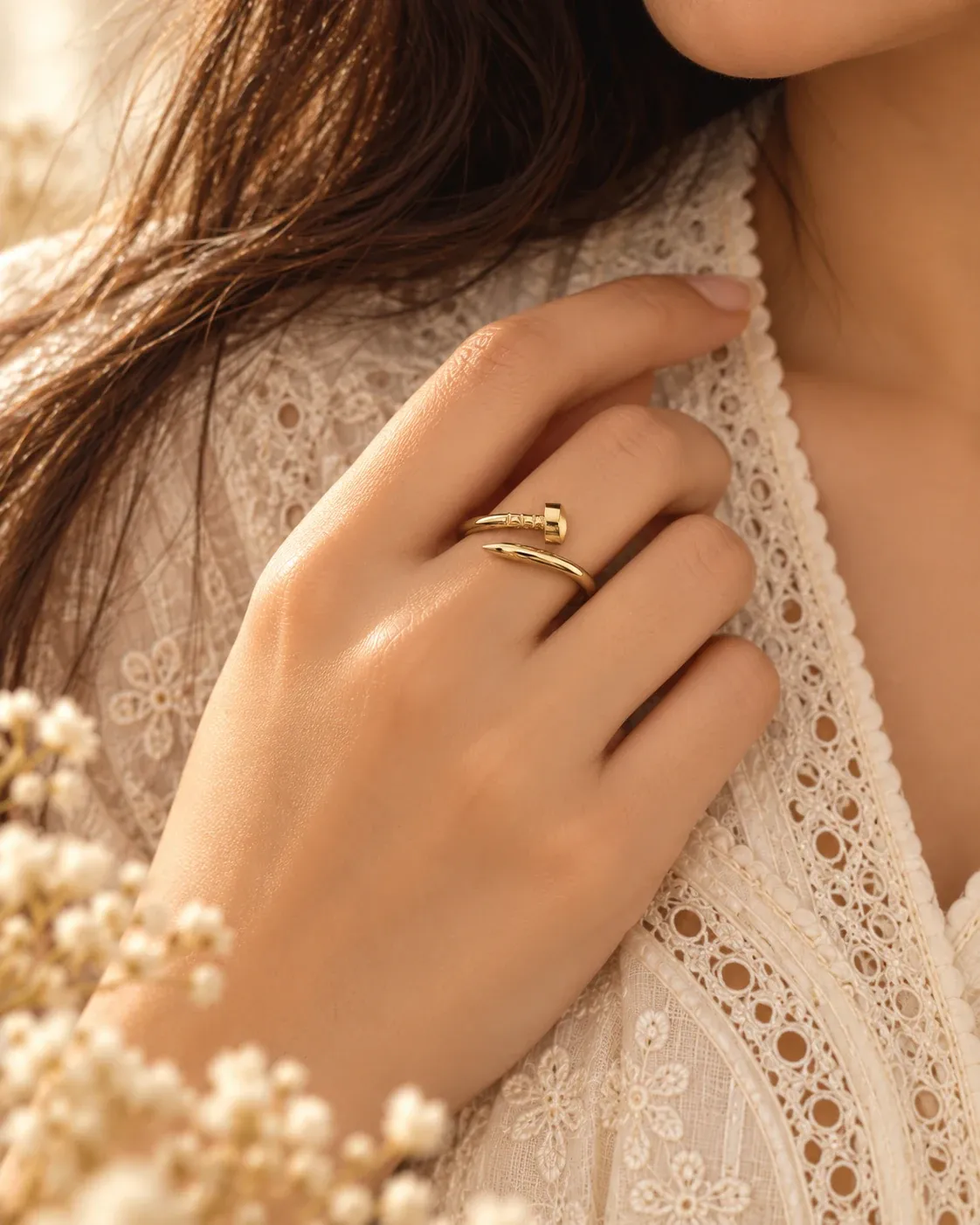 Gold-tone nail-motif ring photographed separately
